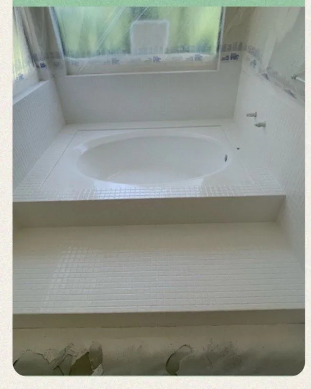 After: Round soaker tub worn and stained beside the same tub refinished in clean white