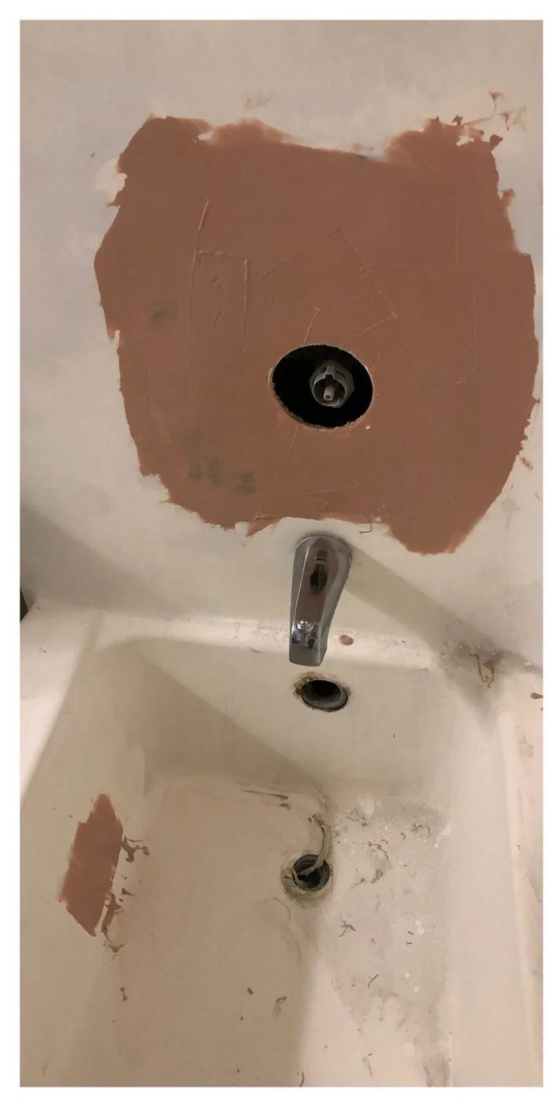 Before: Tub with rust patches and missing fixtures before refinishing beside the same tub refinished in white with new chrome