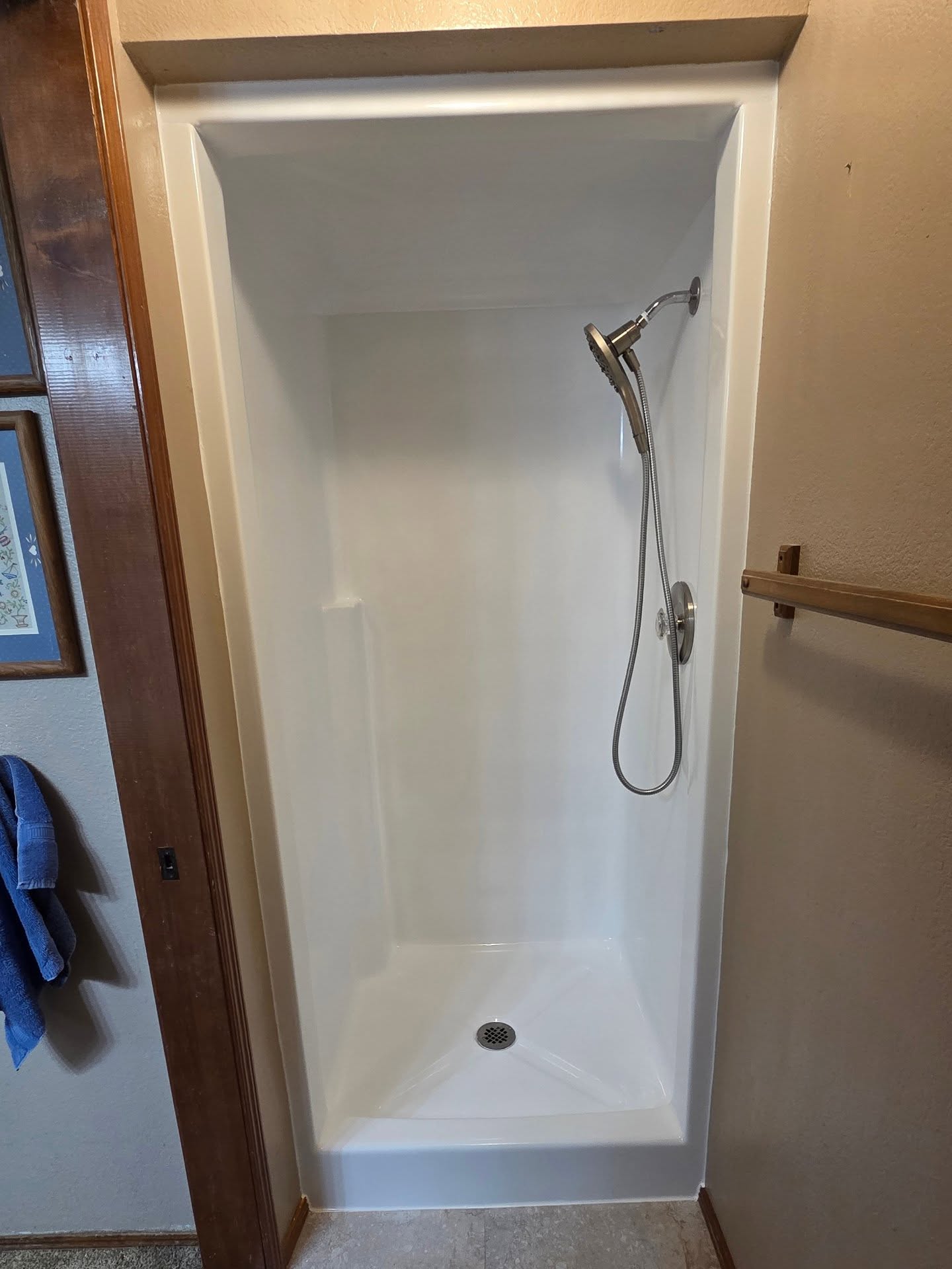 A shower stall refinished to a clean, glossy white