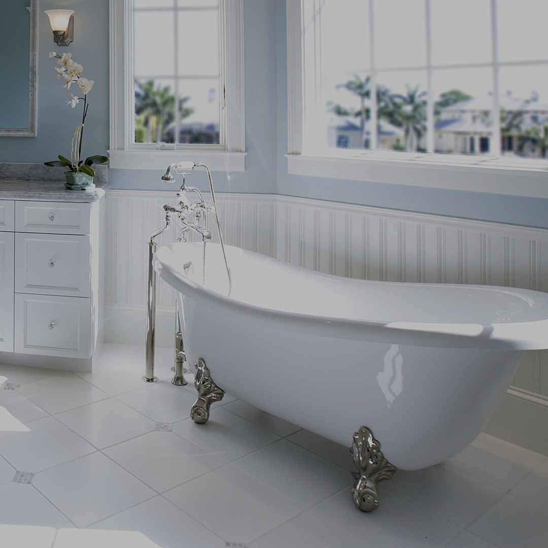 Refinished white clawfoot bathtub in a bright bathroom